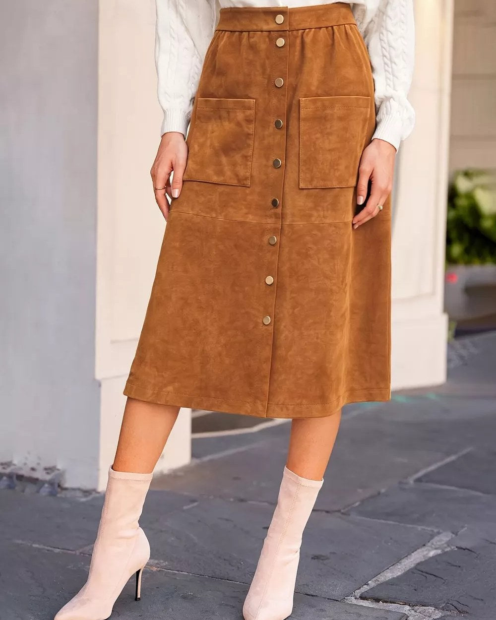 Model wearing caramel button-front midi skirt with pockets