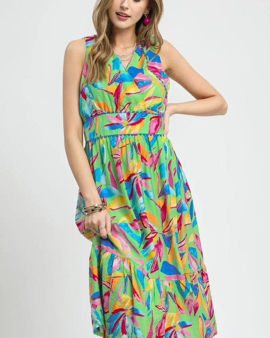 Model wearing green multicolor printed sleeveless midi dress with ruffled hem