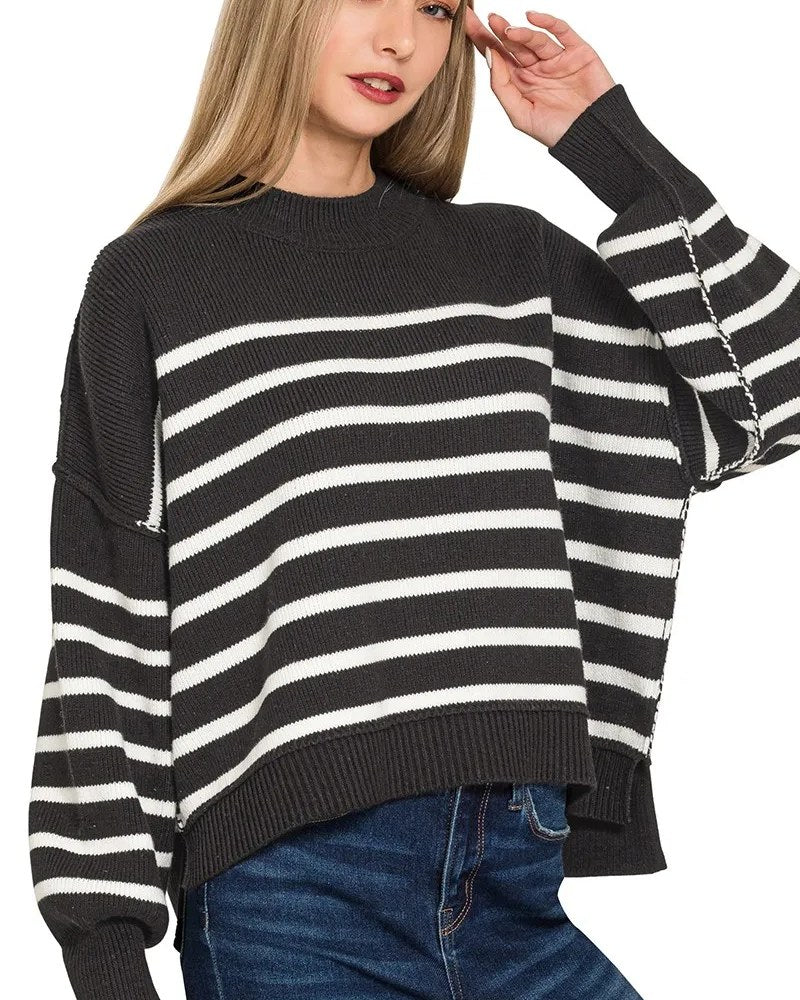 Black and white striped oversized knit sweater with visible seam detailing on a model