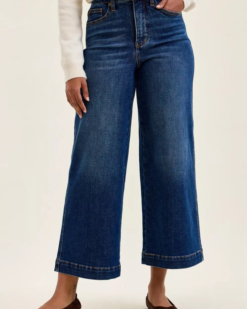 Dark indigo high-waist ankle-length wide-leg jeans worn by a model