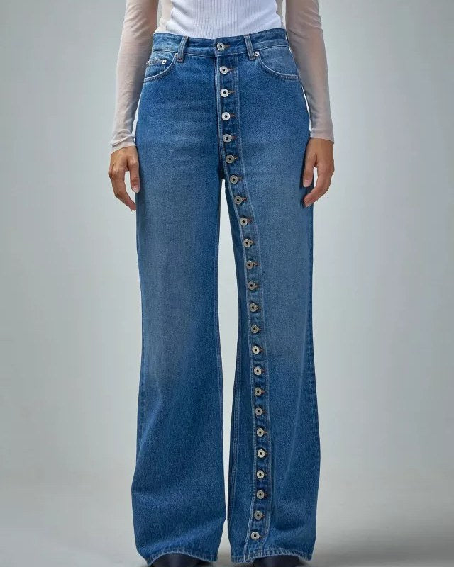 Model wearing dusty-blue wide-leg jeans with asymmetric button fly