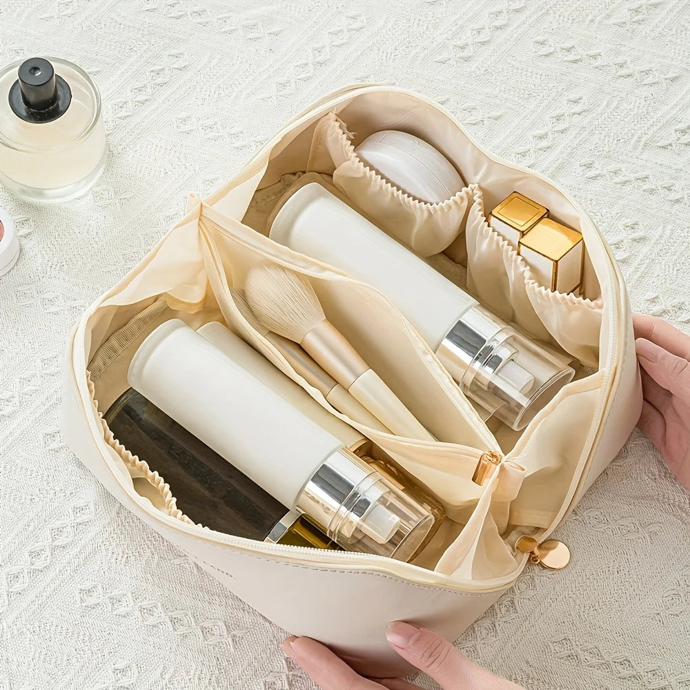 Zip Makeup Organizer Bag — Hands holding an open cream makeup bag showing interior compartments and items